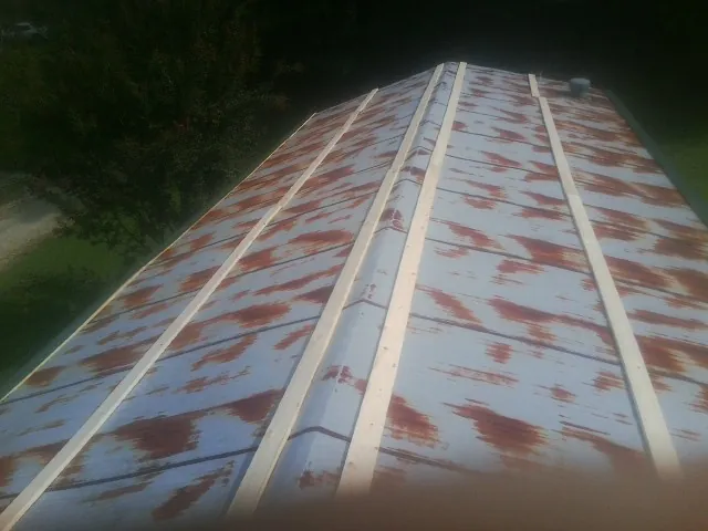 Rusted metal roof panels with new wood purlins before replacement — Storm Damage Roof Repair in Rumson by Roofing Brothers