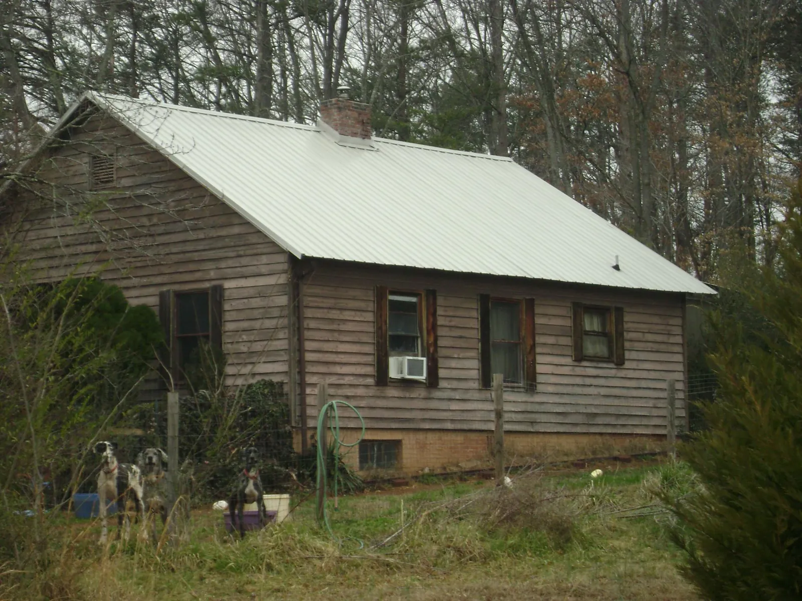 White metal roof on an old wood sided farmhouse, from a Metal Roof Installation job in Rumson